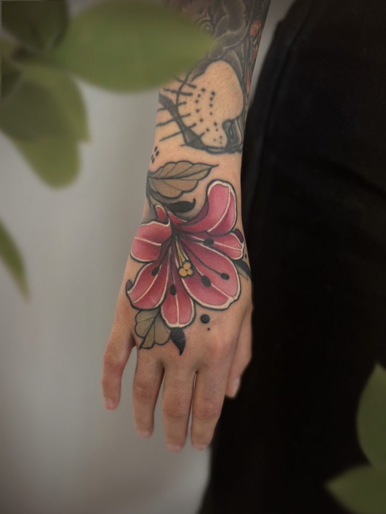 Neo traditional hand flower Lilly tattoo