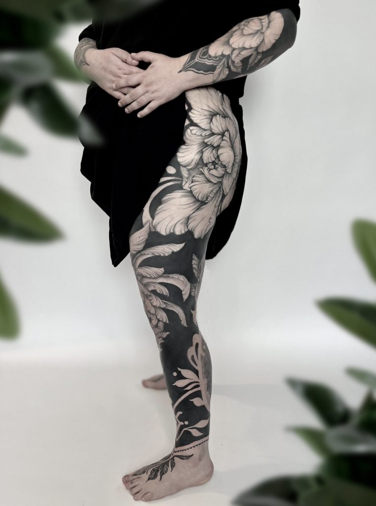 floral black out leg sleeve tattoo